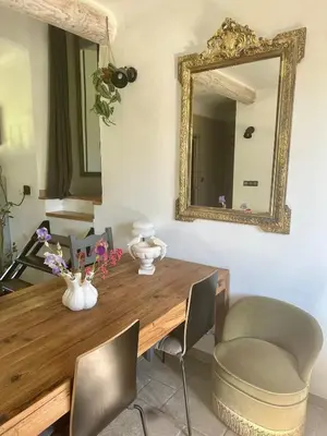 a dining room table with a mirror and chairs at Cocon en Provence à Ménerbes in Ménerbes