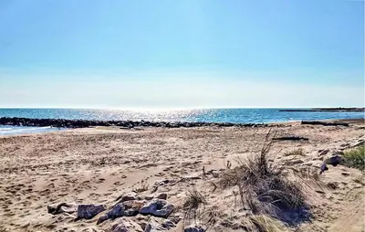 a beach with rocks and the ocean in the background at Amazing Home In Noves in Noves