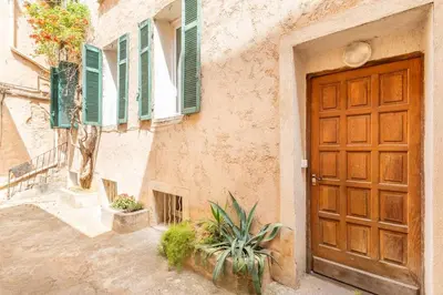 a door to a building with green shutters at Le Petit Saint Esprit, centre, calme, lumineux in Aix-en-Provence