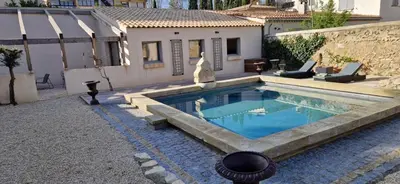 a swimming pool in the backyard of a house at superbe escapade au cœur de la ville clim parking et piscine in Aix-en-Provence