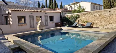 a swimming pool in front of a house at superbe escapade au cœur de la ville clim parking et piscine in Aix-en-Provence