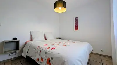 a bedroom with a bed and a television at Villa de charme avec piscine et jacuzzi en Provence in Châteauneuf-de-Gadagne