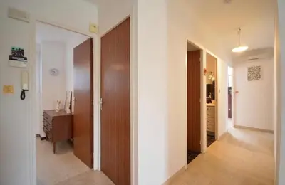 a hallway with a door leading into a room at Les Volets Bleus Provençal house with pool in LʼIsle-sur-la-Sorgue