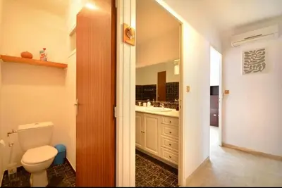 a bathroom with a toilet and a sink at Les Volets Bleus Provençal house with pool in LʼIsle-sur-la-Sorgue