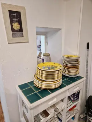 a stack of plates sitting on top of a table at Gîte Moulin de l'Anet in Goult
