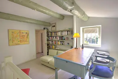 a room with a desk and a chair and a book shelf at La Garrigue de Gordes in Gordes