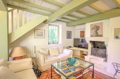 a living room with a couch and a fireplace at La Garrigue de Gordes in Gordes