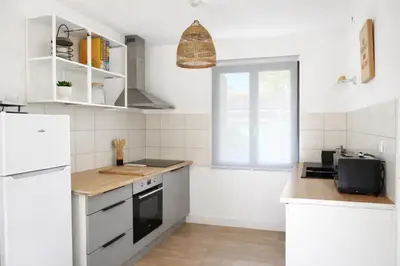 a kitchen with white appliances and a window at Appartement 4 personnes 5 minutes a pieds du centre ville parking gratuit jardin 85m2 in LʼIsle-sur-la-Sorgue