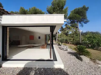 a modern house with a large window on a patio at Villa Cezanne Panorama, City Center on Foot in Aix-en-Provence