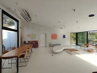 a living room with a wooden table and chairs at Villa Cezanne Panorama, City Center on Foot in Aix-en-Provence