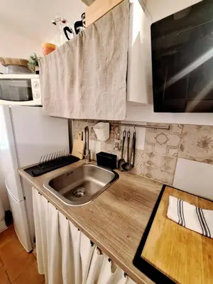 a kitchen with a sink and a counter top at Le Cocon d'Emy in Aix-en-Provence