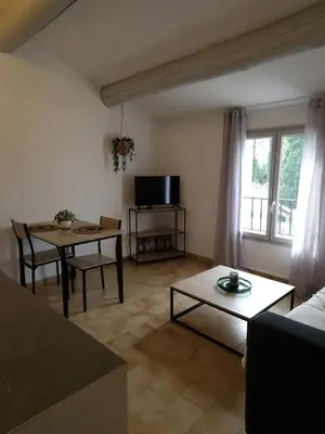 a living room with a table and a dining room at C' Cosy in Entraigues-sur-la-Sorgue