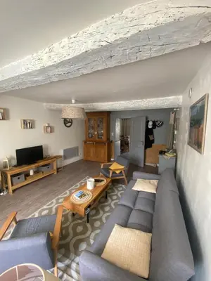 a living room with a couch and a table at La Cigale Bleue in Villes-sur-Auzon
