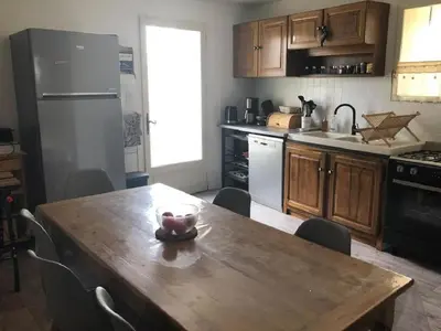 a kitchen with a wooden table with a bowl on it at La Cigale Bleue in Villes-sur-Auzon