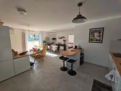 a kitchen and living room with a table and chairs at Casa LoVaPi Cozy recent 2-bedroom house, garden, private parking in Salon-de-Provence