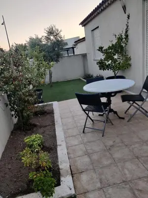 a patio with a table and chairs in a yard at Casa LoVaPi Cozy recent 2-bedroom house, garden, private parking in Salon-de-Provence