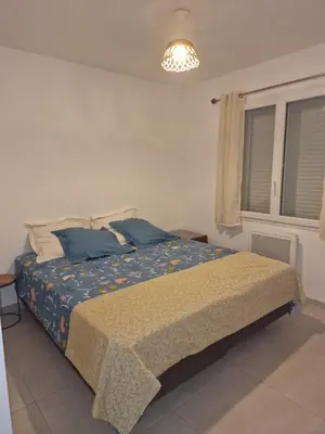 a bedroom with a bed with blue pillows at Casa LoVaPi Cozy recent 2-bedroom house, garden, private parking in Salon-de-Provence