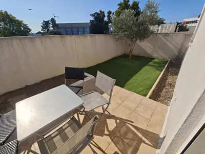 a patio with a table and chairs and a small yard at Casa LoVaPi Cozy recent 2-bedroom house, garden, private parking in Salon-de-Provence
