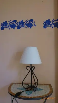 a lamp sitting on top of a table with a wall at Très charmant Mazet au coeur du Luberon in Roussillon