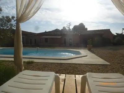 two white chairs sitting next to a swimming pool at Très charmant Mazet au coeur du Luberon in Roussillon