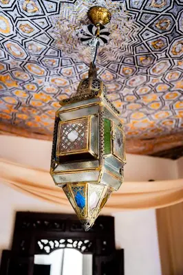 a chandelier hanging from the ceiling of a room at La Cour Secrète - 2 Suites avec Balnéo privée in Carpentras