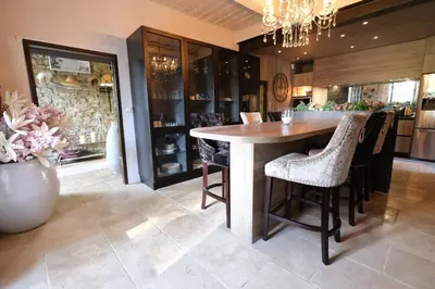 a kitchen with a large wooden table and chairs at luxury farm jacuzzi heated pool in Isle sur la sorgue in Lagnes