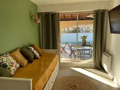 a bedroom with a bed with a view of the ocean at Une maison provençale dans la pinède - A Provençal house in a pine forest in Lambesc