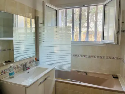 a bathroom with a sink and a window at Une maison provençale dans la pinède - A Provençal house in a pine forest in Lambesc