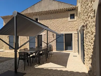 a table and chairs in front of a building at La Ferme Au bord de l etang de la Bonde in Sannes