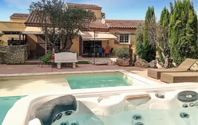 a swimming pool in front of a house at Maison Avec Piscine Privée in Entraigues-sur-la-Sorgue