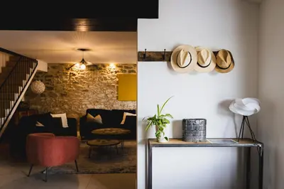 a living room with a couch and a table at Le mas des cerisiers - piscine chauffée in Caumont-sur-Durance