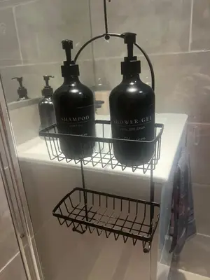 two black bottles on a shelf in a bathroom at Appartement cosy & calme avec parking privé & terrasse in Mazan