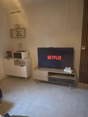 a living room with a netflix screen on the wall at Appartement cosy & calme avec parking privé & terrasse in Mazan