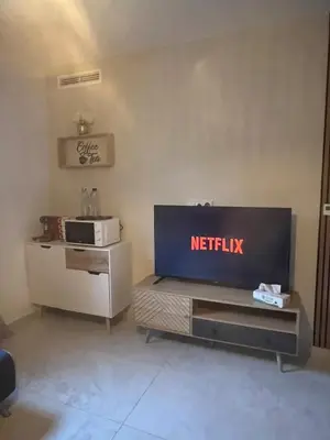 a living room with a netflix sign on the wall at Appartement cosy & calme avec parking privé & terrasse in Mazan