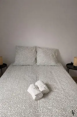 a bed with two towels on it with two pillows at Villa Alberta Charming 10-person villa in Provence in Éguilles