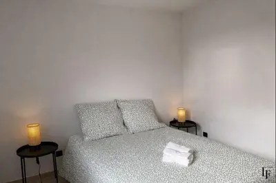 a bedroom with a bed with two lamps on two tables at Villa Alberta Charming 10-person villa in Provence in Éguilles