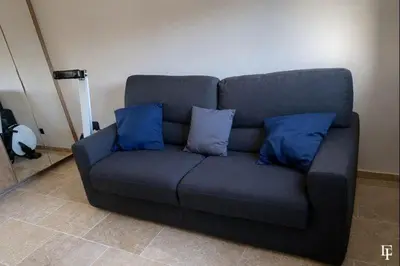 a blue couch with two blue pillows on it at Villa Alberta Charming 10-person villa in Provence in Éguilles