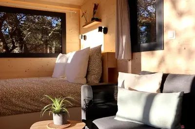 a bedroom with a bed and a couch and a window at Tiny House Sainte Victoire - Brasserie Aix Pression in Rognes