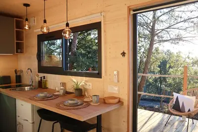 a kitchen with a counter in a tiny house at Tiny House Sainte Victoire - Brasserie Aix Pression in Rognes