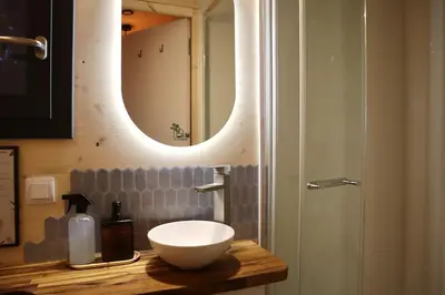 a bathroom with a sink and a mirror on a counter at Tiny House Sainte Victoire - Brasserie Aix Pression in Rognes