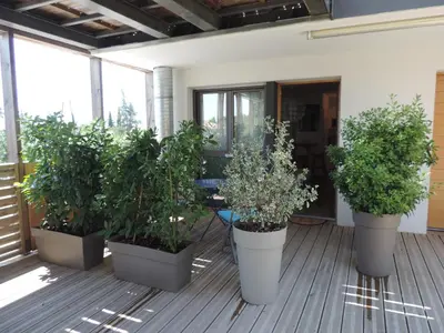 a row of potted plants on a porch at Studios Nuitée en Provence in Aix-en-Provence