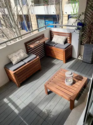 two benches and a table on a balcony at Modern City Center apartment with parking! in Aix-en-Provence