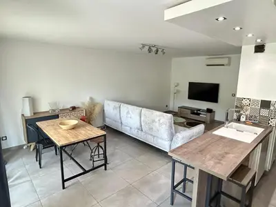 a living room with a couch and a table at Modern City Center apartment with parking! in Aix-en-Provence