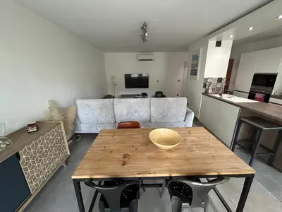 a living room with a table and a couch at Modern City Center apartment with parking! in Aix-en-Provence