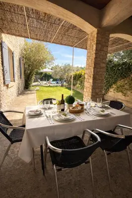 a white table with chairs and food on it at Mas Caumontois Provençal charm & private pool in Caumont-sur-Durance