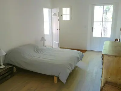 a bedroom with a large bed in a room with windows at Provençal House With Pool Near Roussillon in Roussillon