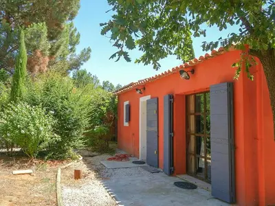 an orange house with an orange door and trees at Provençal House With Pool Near Roussillon in Roussillon