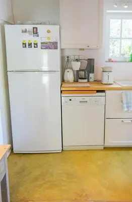 a kitchen with white appliances and a white refrigerator at Provençal House With Pool Near Roussillon in Roussillon