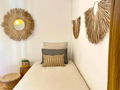 a bed in a room with two mirrors on the wall at Provençal Villa At Domaine in Cornillon-Confoux