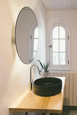 a bathroom with a black sink and a mirror at Provençal Villa At Domaine in Cornillon-Confoux